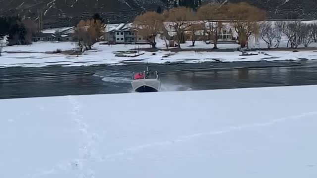 Boat Slides Through Snow Between Lakes