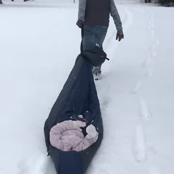 Daddy pulling Alex in the snow!