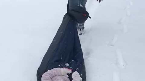 Daddy pulling Alex in the snow!