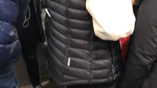 Red astronaut space suit on subway