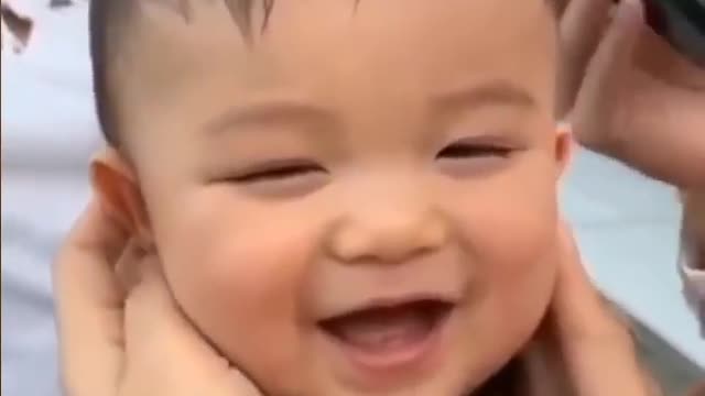 baby cries with laughter and bursts out laughing