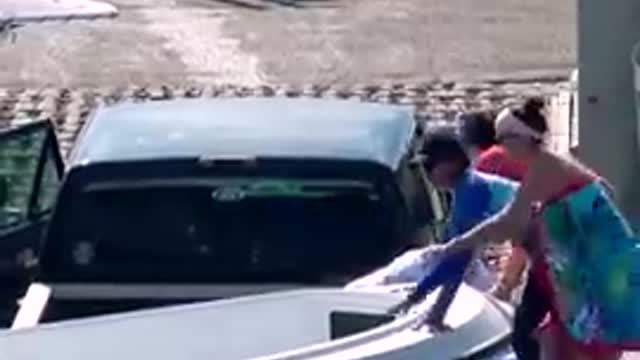 LADY JUMPS IN! BOAT SINKING THEIR TRUCK!