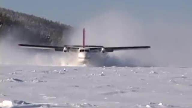 Twin Otter landing frozen lake with wheel-skis