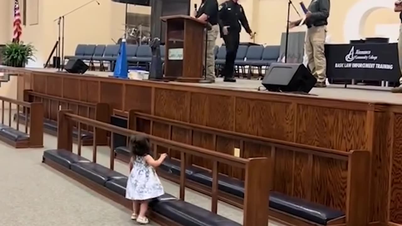 Little girl has cutest reaction to dad's police graduation