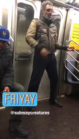 Friyay guy with glasses playing air guitar in subway