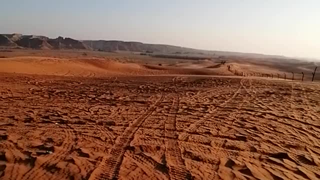 Motor riding in red sand desert of Saudi Arabia