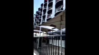 Watch as quarantined workers sing from balcony