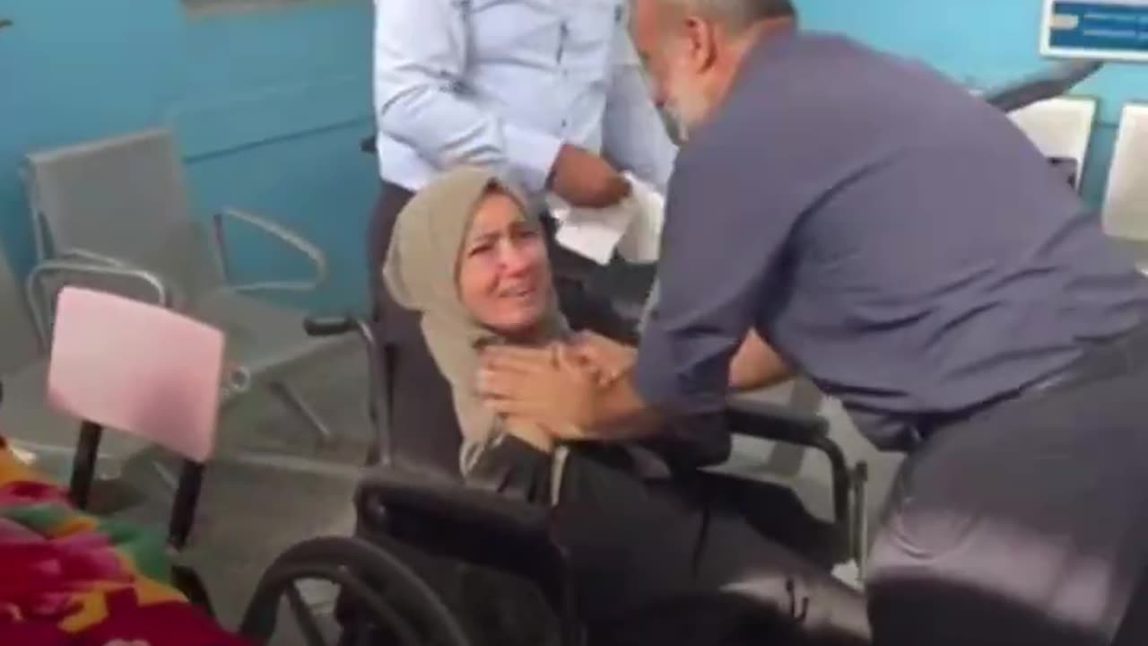 Palestinian woman gives her dead child one last kiss before burial