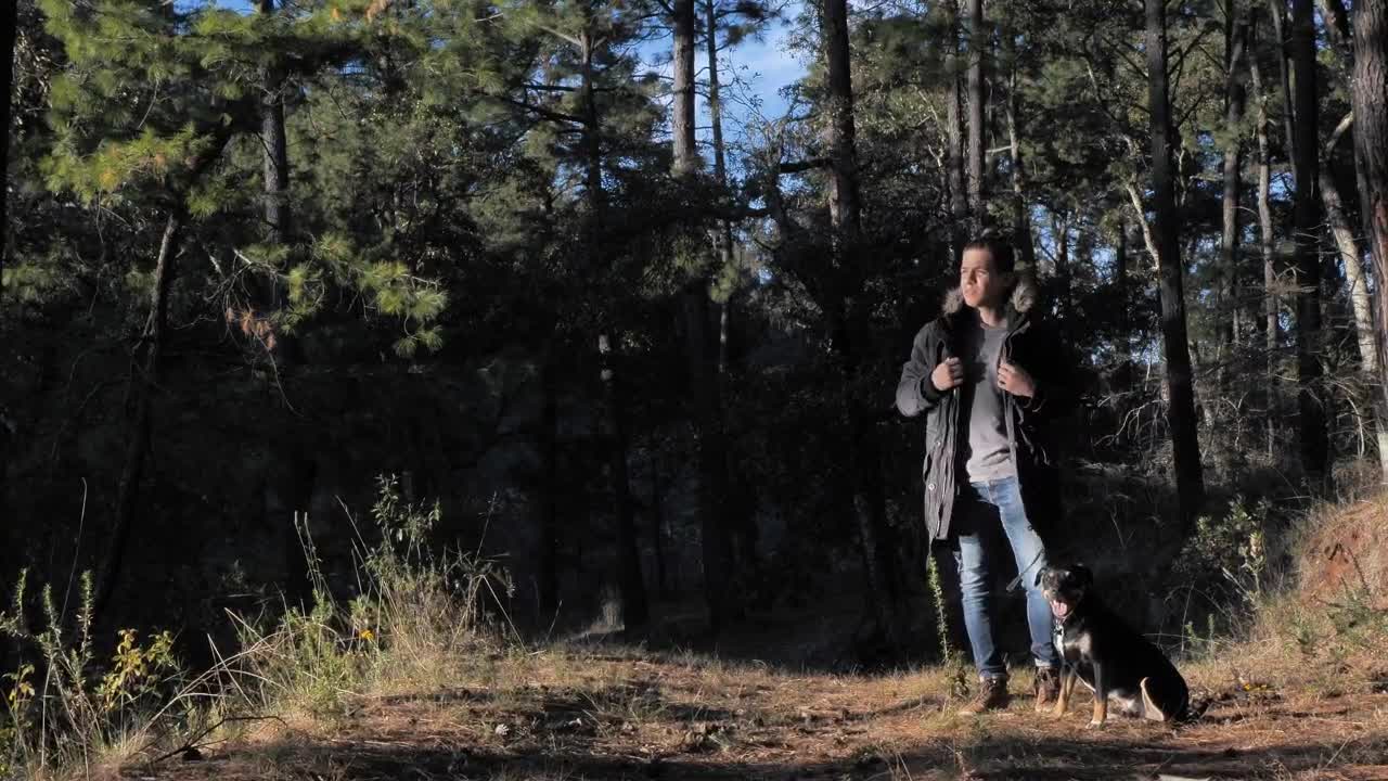 Man in the woods with his dog