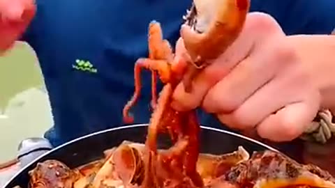 Chinese Fisherman eating and cooking seafood