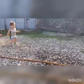 baby plays and runs away from water