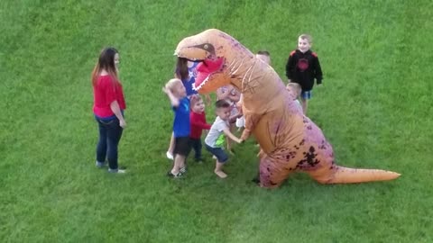Group Of Kids Ambush Man In A T-Rex Costume