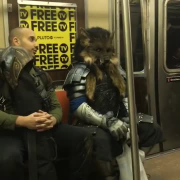 Woman sings "into you" on subway station, man in wolf costume sits behind her casually