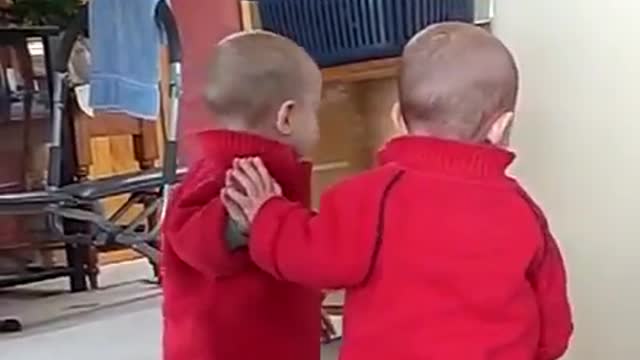 Baby loves his friend of the mirror very funny