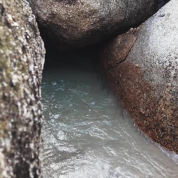 A Beach Waves in the Middle of Boulders