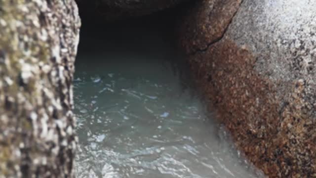 A Beach Waves in the Middle of Boulders