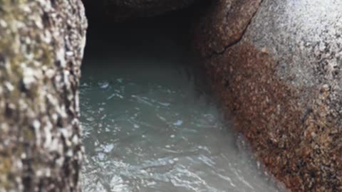 A Beach Waves in the Middle of Boulders