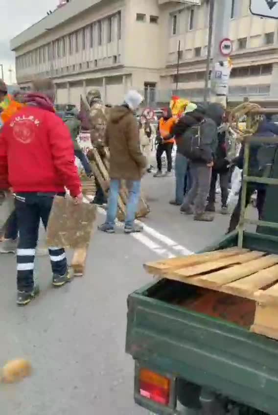 GENOVA PORT, ITALY: Port workers are building the barricades