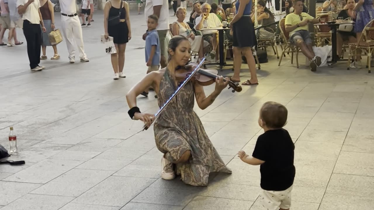 Street Violinist Enchants Young Boy