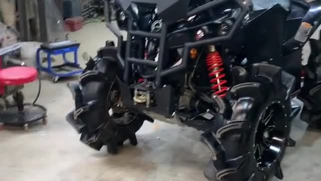 A mechanic modifies a heavy motorcycle