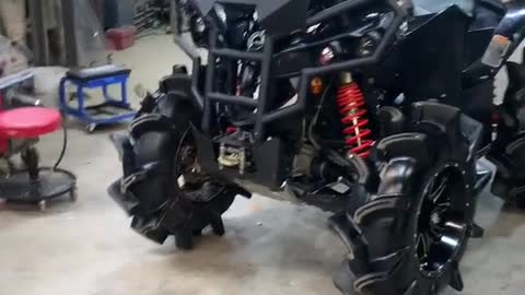 A mechanic modifies a heavy motorcycle