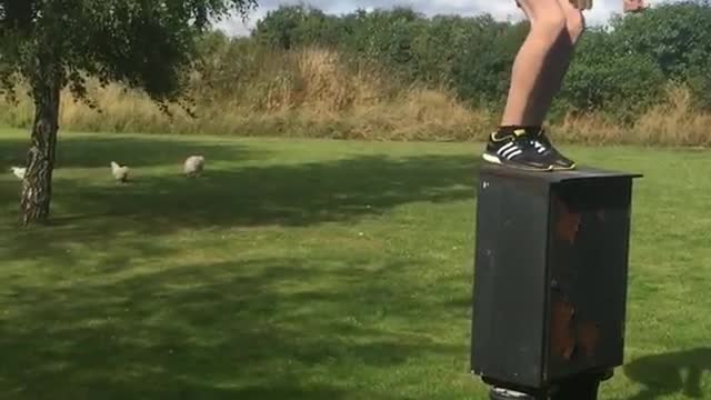 White shirt kid backflips off green box and hits head