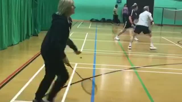 Older woman badminton hit fail