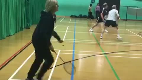 Older woman badminton hit fail