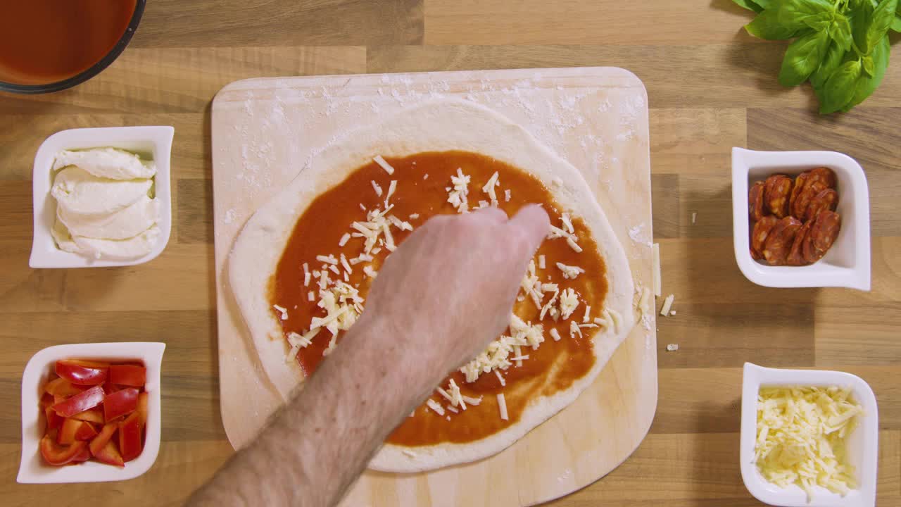 Top View Male Sprinkles Grated Cheese on Pizza