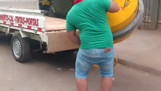 Man Loads Concrete Mixer into a Truck by Himself