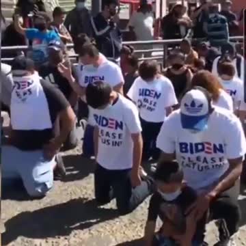 Migrants Kneel At Port Of Entry In Like-New 'Biden Please Let Us In!' T-Shirts