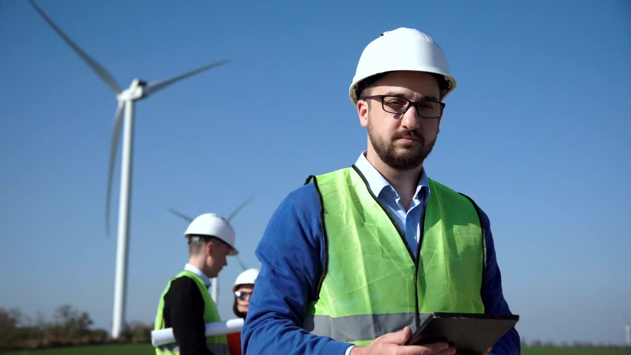 Engineer standing on a wind turbines field