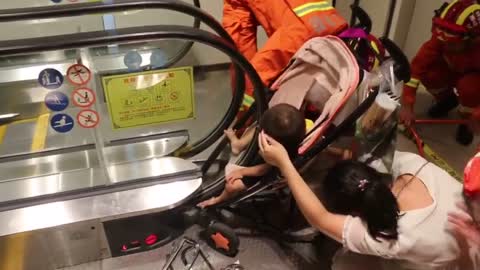 Calm Baby In Pushchair Traps Toes Under Escalator Rail