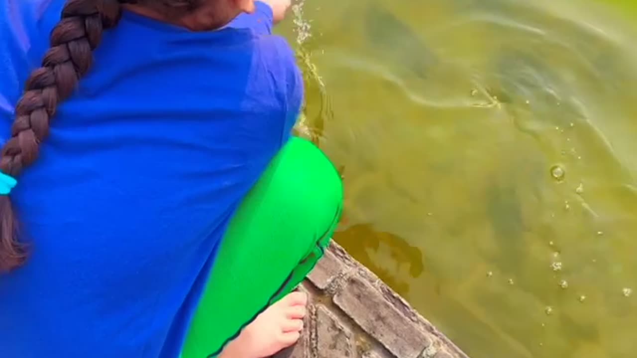 Sweet baby playing with fishes 😊😊