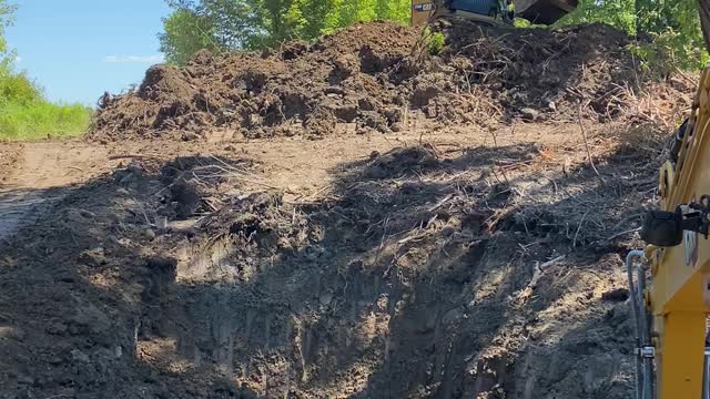 CAT 259D and 306cr excavating small pond