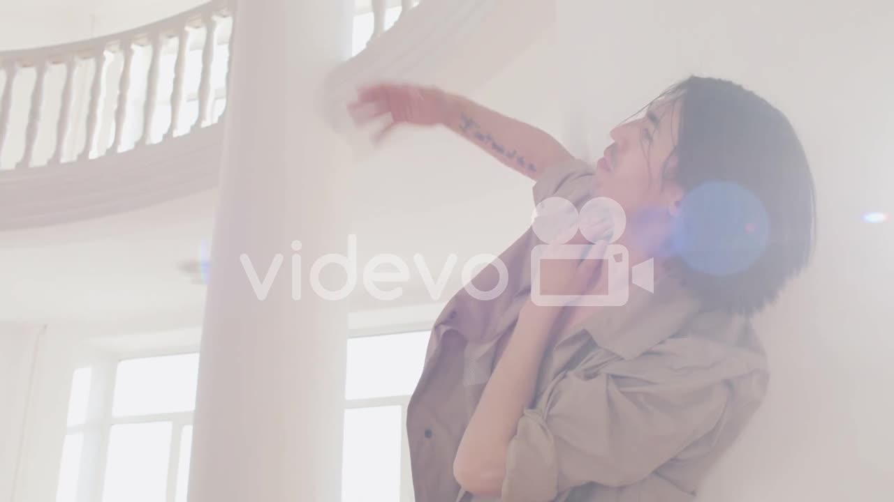 Bottom View Of Contemporary Male Japanese Dancer Training Dance Moves Leaning On The Wall In The Stu