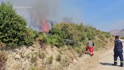 Firefighters battle flames in parts of Albania.mp4