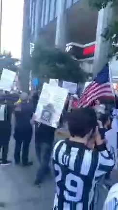 Anti-vaccine protesters rally outside the news