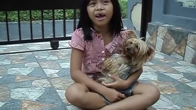 Little Balinese sings the national anthem of Indonesia.