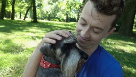 Happy boy cuddles and strokes his cute dog, slow motion shot at