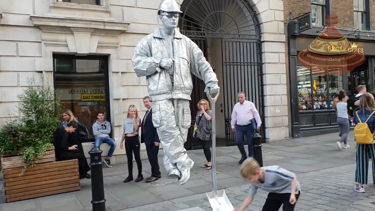 Silver man - London street performer - floating and levitating trick