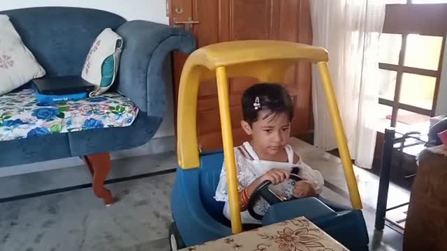 A beautiful kid playing with car