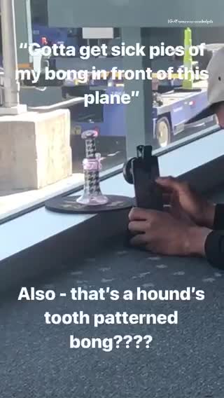 Guy trying to take picture of purple dotted bong airport airplane
