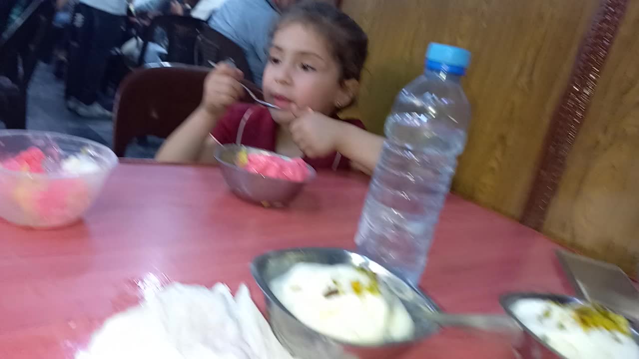 Two children enjoying ice cream in Bekdashطفلان يستمتعان بتناول البوظة في بكداش