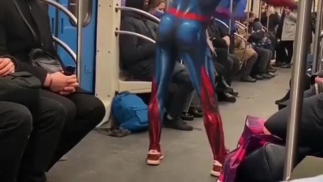 Spiderman dances on the train.