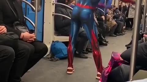 Spiderman dances on the train.