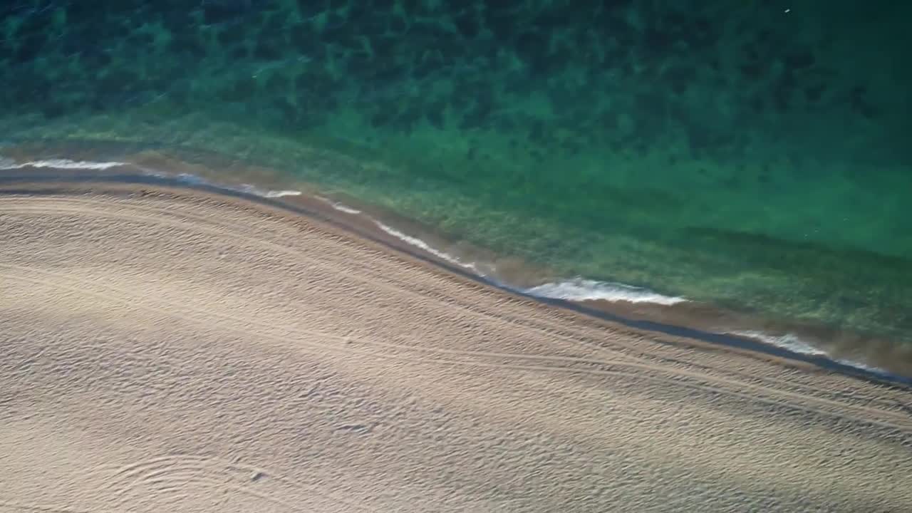 View of the turquoise blue sea from a sunny beach