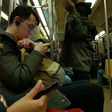 Guy quietly vogues and dances by himself on subway train