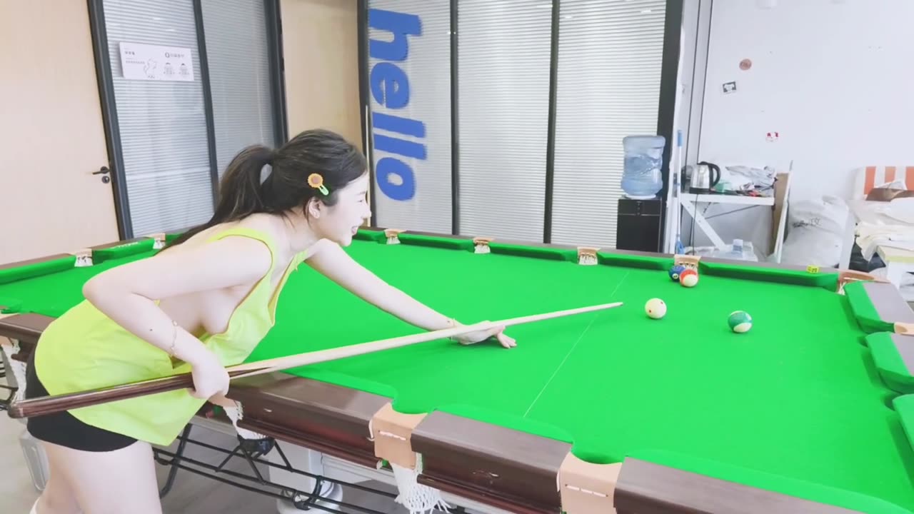 Sexy asia girl wearing green Low-cut vest playing billiard