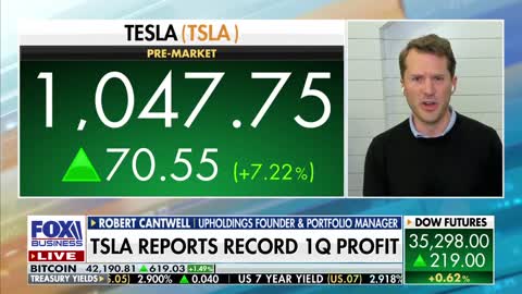 Tesla stock trades higher on record quarter